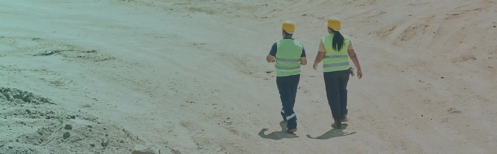 two warehoues workers with safety vests and helmets